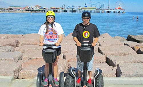 Man and Woman riding Segway on the Seawall Cruise Tour.
